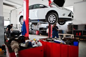 Car repair and maintenance theme. Mechanic in uniform working in